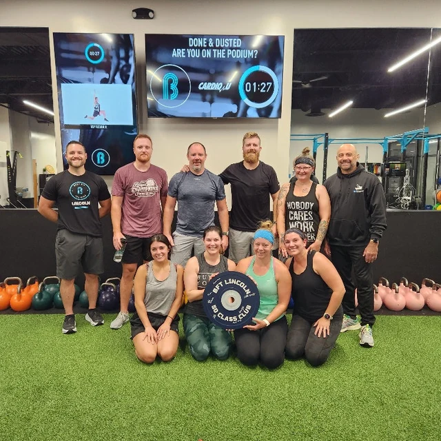 Custom bumper plate sign with gym members